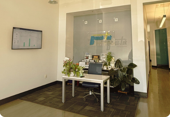 Bench-Tek lobby display showcasing sustainability production metrics