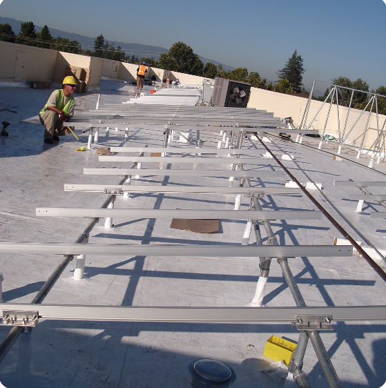 Elevated solar racking system being installed on the ACE Hardware rooftop